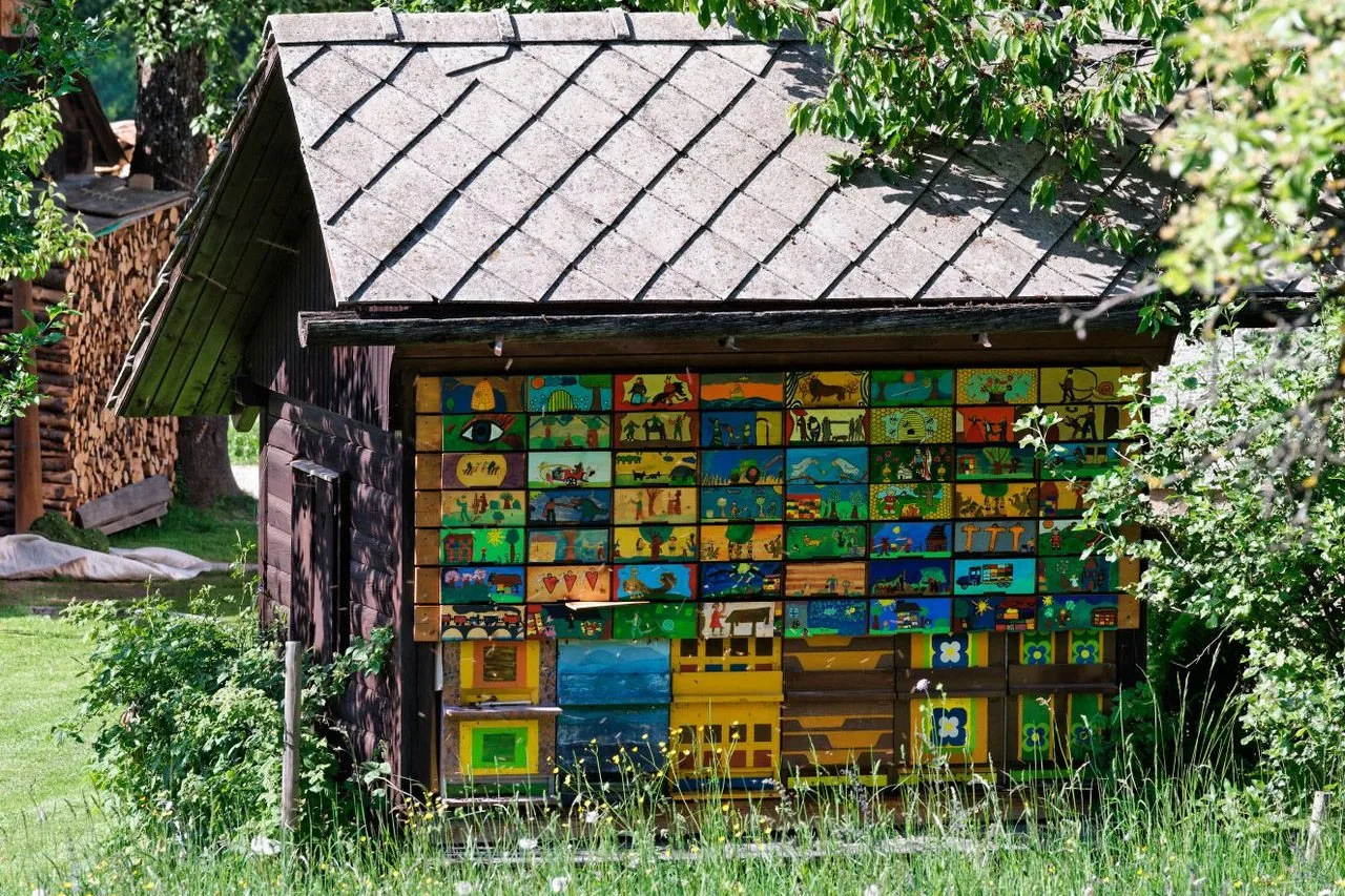 A Slovenian apiary with painted beehive panels